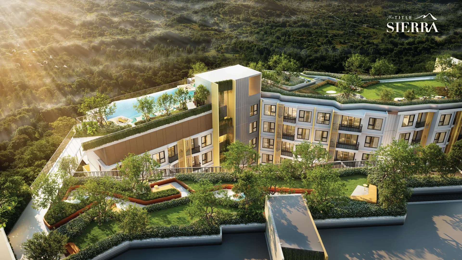 Bird's-eye view of the roof gardens and the rooftop pool among forested hills